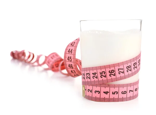 Glass of milk with measuring tape isolated on white — Stock Photo, Image