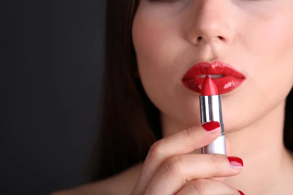 Girl with sexy red lips and pomade on dark background — Stock Photo, Image