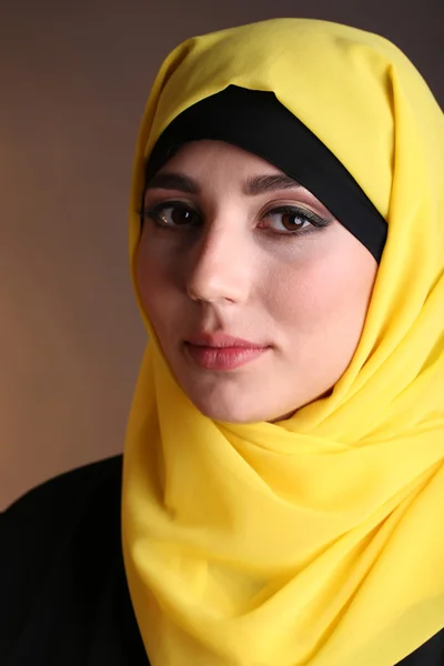 Beautiful muslim arabic woman on dark color background — Stock Photo, Image