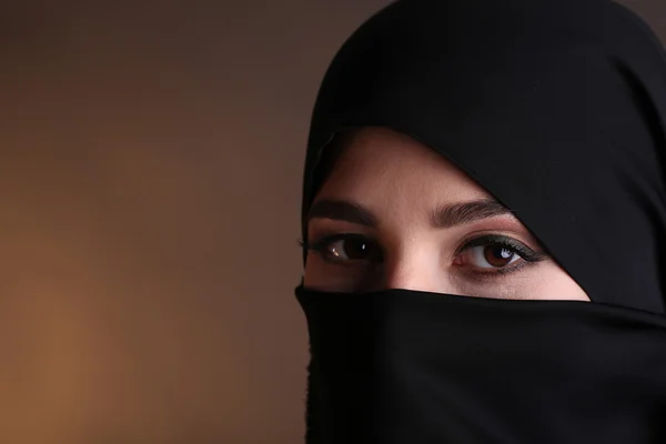 Beautiful muslim arabic woman in paranja on dark color background — Stock Photo, Image