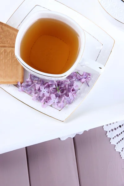 Composition with cup of tea, teapot on tray, on color wooden background — Stock Photo, Image