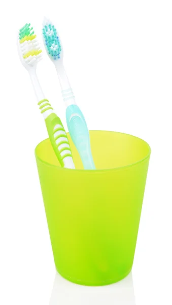 Toothbrushes in glass isolated on white — Stock Photo, Image