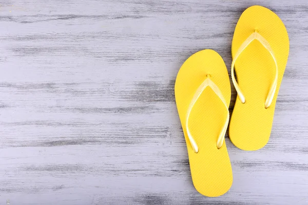 Bright flip-flops on color wooden background — Stock Photo, Image