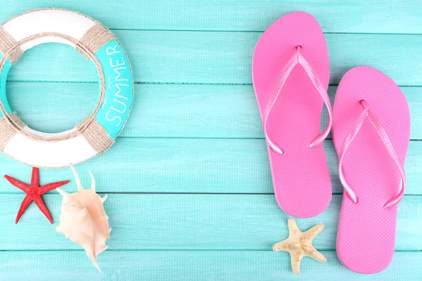 Bright flip-flops on color wooden background — Stock Photo, Image