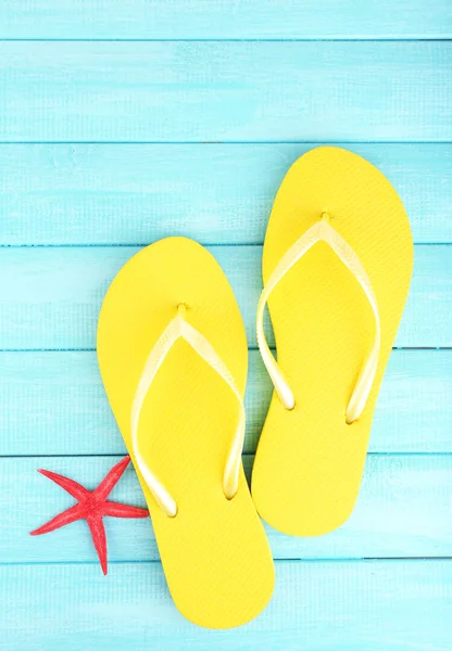 Bright flip-flops on color wooden background — Stock Photo, Image