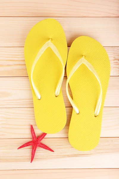 Bright flip-flops on wooden background — Stock Photo, Image