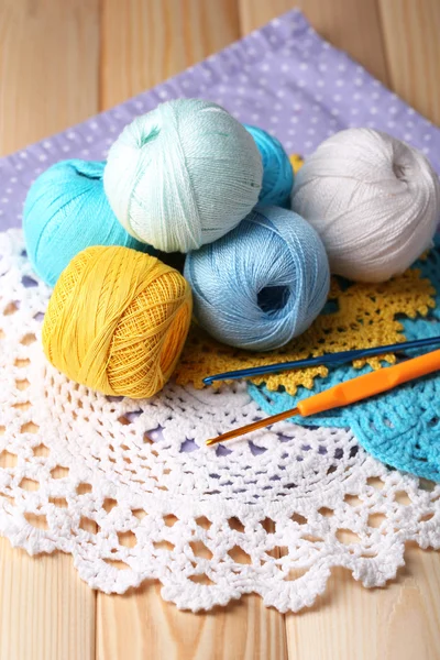 Colorful clews, napkin and crochet hooks on wooden background — Stock Photo, Image