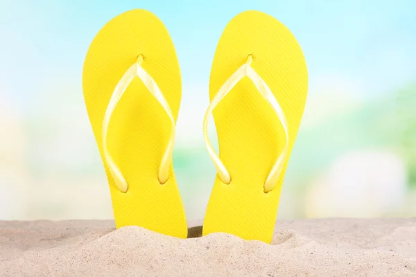 Bright flip-flops on sand, on nature background — Stock Photo, Image