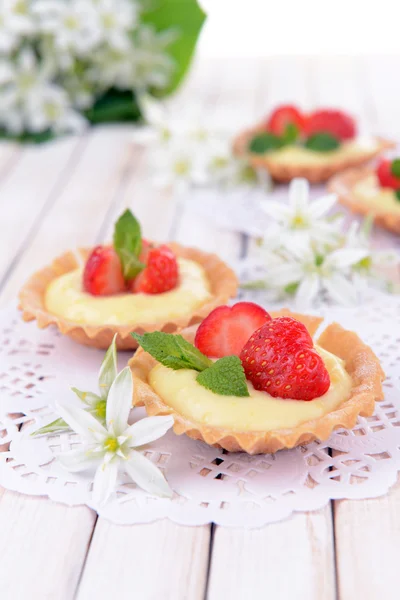 Tasty tartlets with strawberries on table close-up — Stock Photo, Image