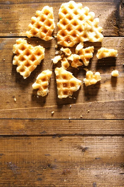 Crushed waffle on wooden background — Stock Photo, Image