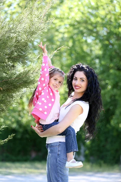 Glad mamma och dotter. promenad i den gröna parken — Stockfoto