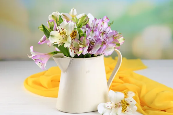 Bouquet of freesias in pitcher on table on natural background — Stock Photo, Image