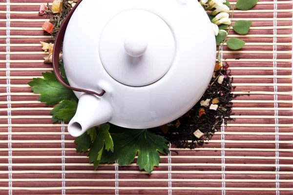 Herbal natural floral tea infusion with dry flowers and herbs ingredients, on bamboo mat background — Stock Photo, Image