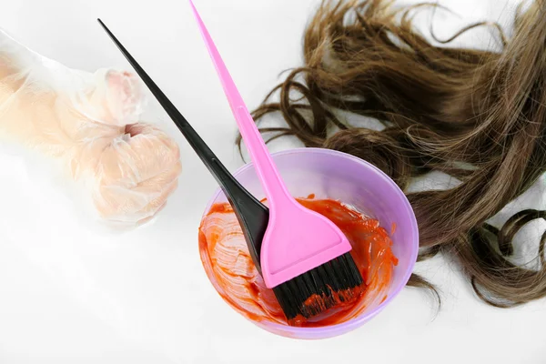 Mão feminina em luvas mergulhos com escova para coloração de cabelo, isolado em branco — Fotografia de Stock