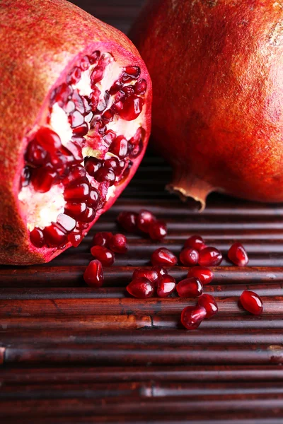 Ripe pomegranates on bamboo mat background — Stock Photo, Image