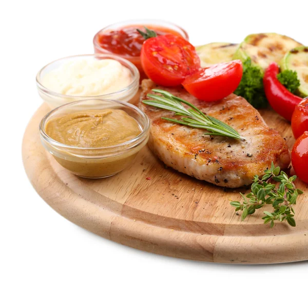 Grilled steak with spices, herbs and vegetables  on wooden board, isolated on white — Stock Photo, Image