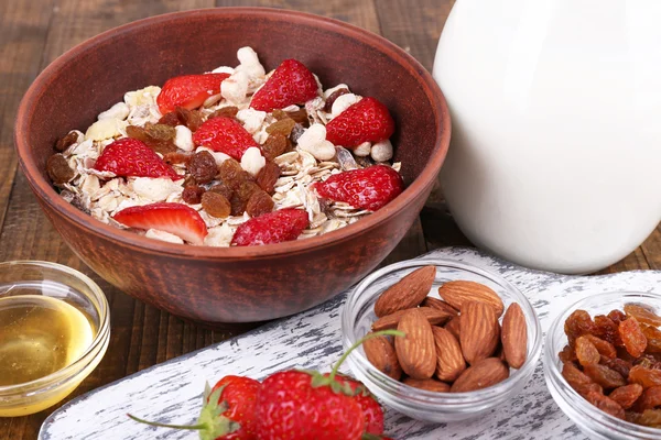 Healthy cereal with milk and strawberry on wooden table — Stock Photo, Image