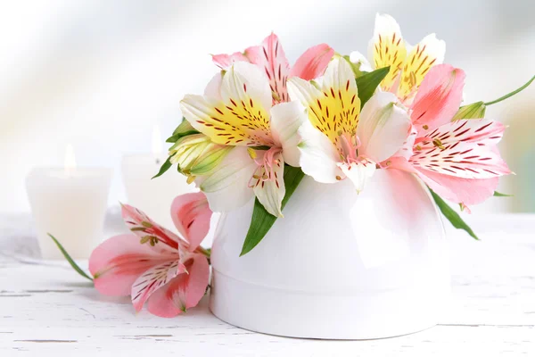 Alstroemeria flowers in vase on table on light background — Stock Photo, Image