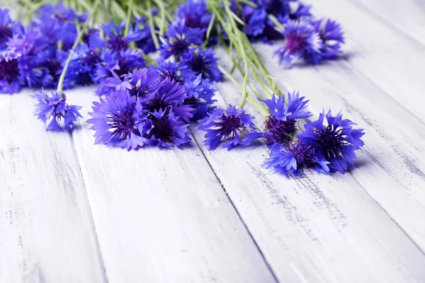 Beautiful cornflowers on wooden background — Stock Photo, Image