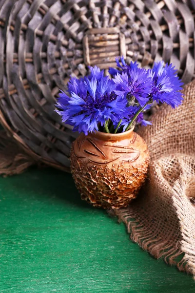 Beautiful cornflowers in vase on wooden background — Stock Photo, Image