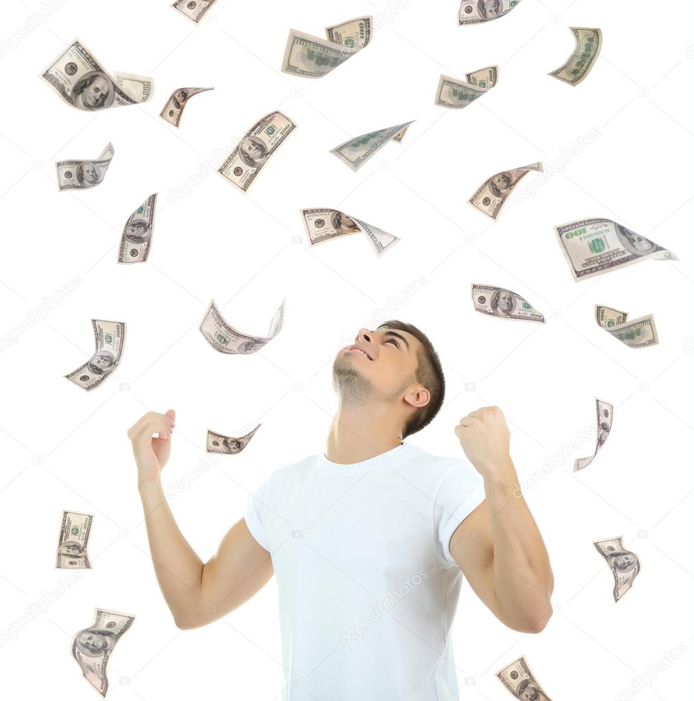 Happy man enjoying rain of money, isolated on white
