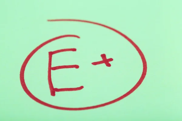 Grade E written on an exam paper — Stock Photo, Image