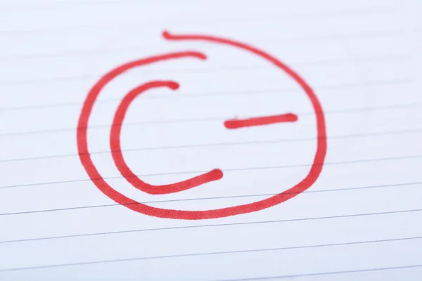 Grade C- written on an exam paper — Stock Photo, Image