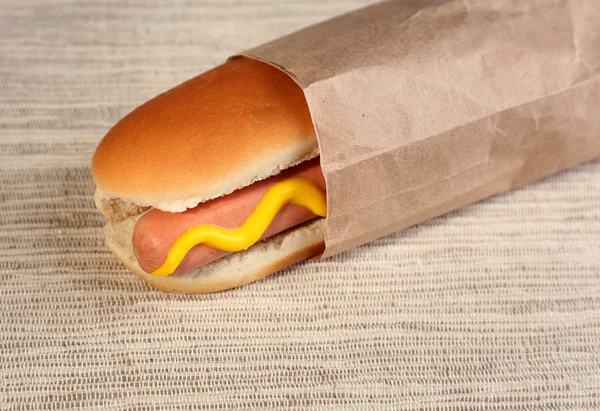 Tasty hot dog on paper — Stock Photo, Image