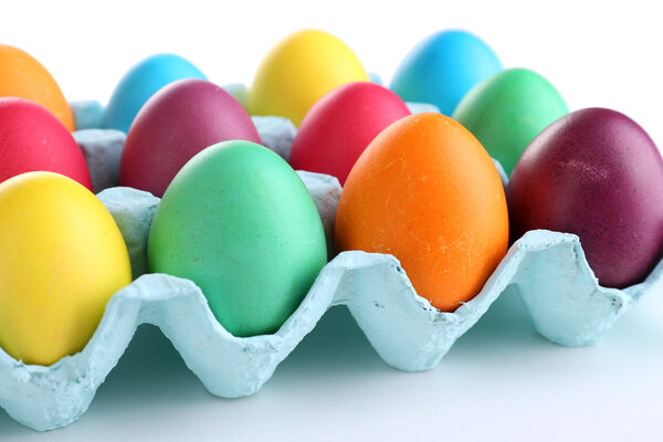 Colorful Easter eggs in tray isolated on white
