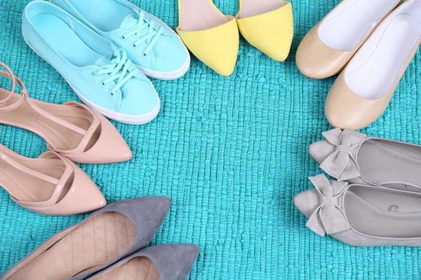 Female fashion shoes on blue carpet — Stock Photo, Image