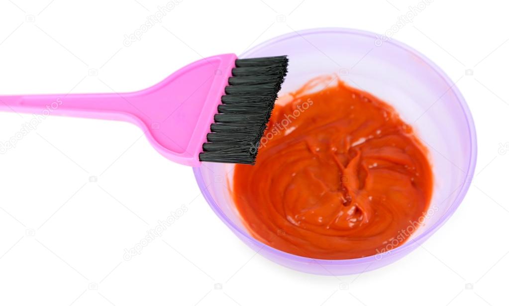 Bowl with hair dye and brush for hair coloring, isolated on white