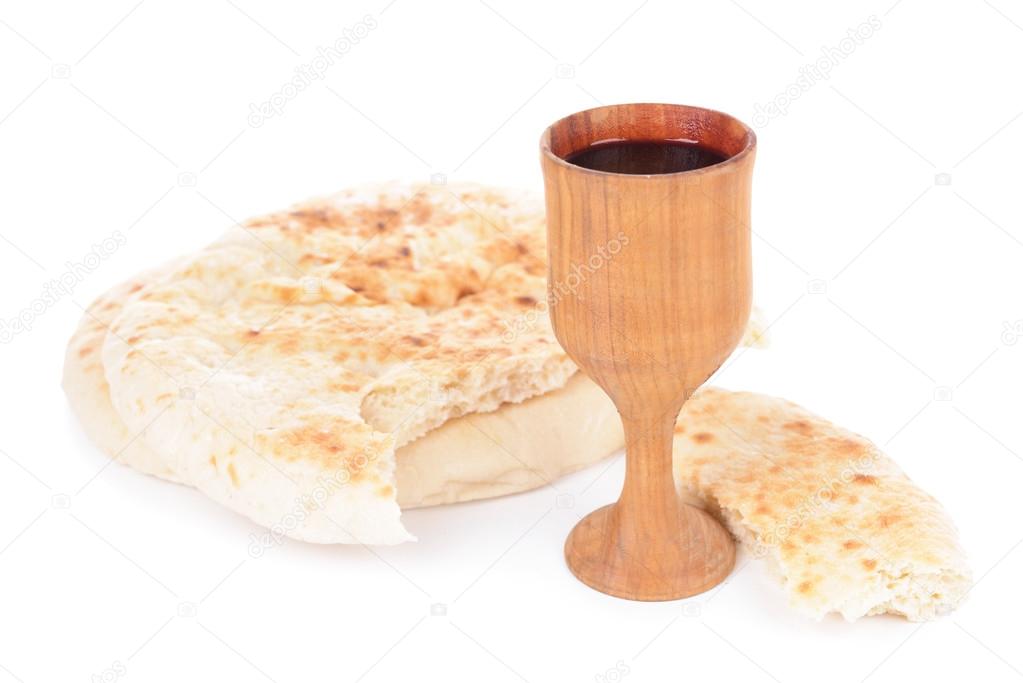 Cup of wine and bread isolated on white