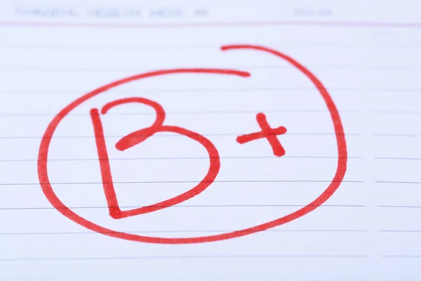 Grade B written on an exam paper — Stock Photo, Image