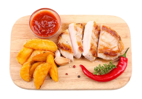 Grilled steak with fried potato pieces and grilled vegetables  on wooden board, isolated on white — Stock Photo, Image