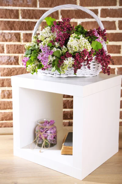 Lilac flowers in wicker basket — Stock Photo, Image