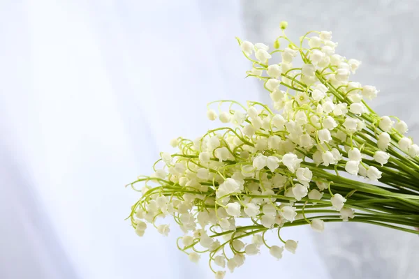 Beautiful lilies of the valley on cloth background — Stock Photo, Image