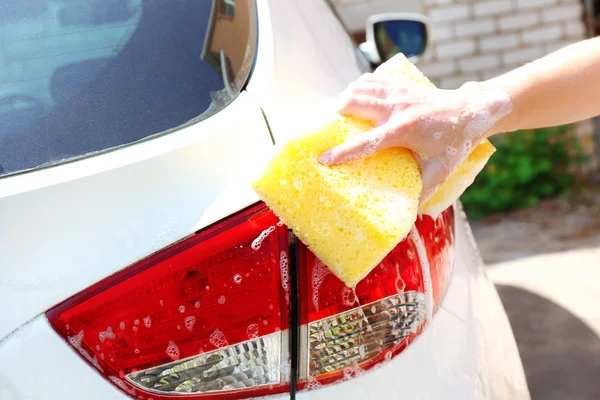 Outdoor car wash with yellow sponge — Stock Photo, Image