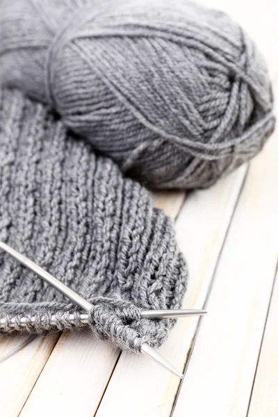 Knitting with spokes on wooden background — Stock Photo, Image