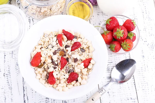 Healthy cereal with strawberry and milk on wooden table — Stock Photo, Image