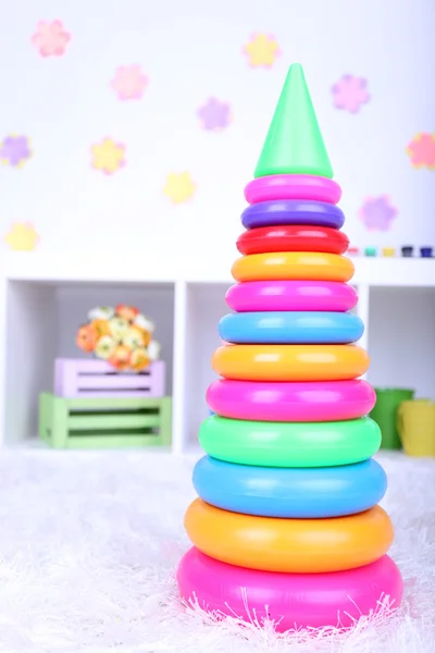 Plastic toy pyramid in children room — Stock Photo, Image