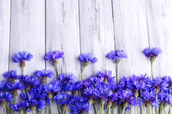 Beautiful cornflowers on wooden background — Stock Photo, Image