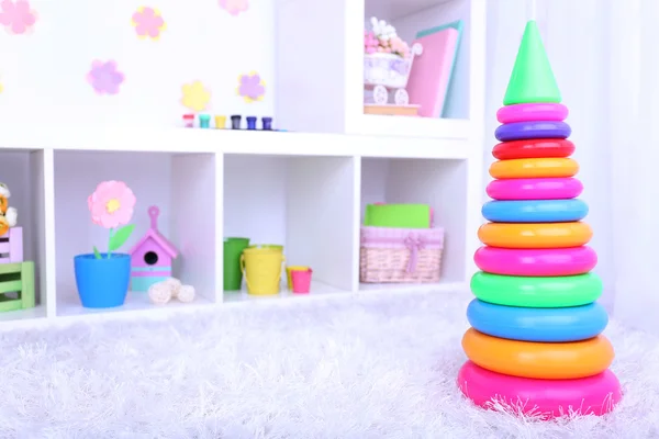 Plastic toy pyramid in children room — Stock Photo, Image