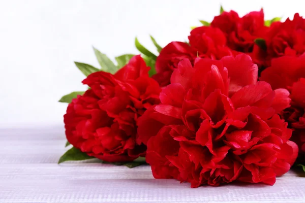 Beautiful pink peonies on wooden table — Stock Photo, Image