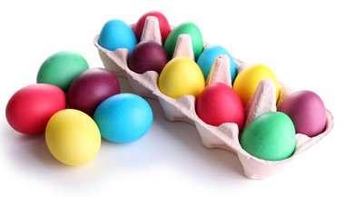Colorful Easter eggs in tray isolated on white clipart
