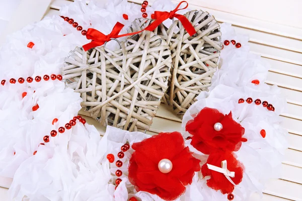 Decorative wreath with wicker hearts on wooden background — Stock Photo, Image