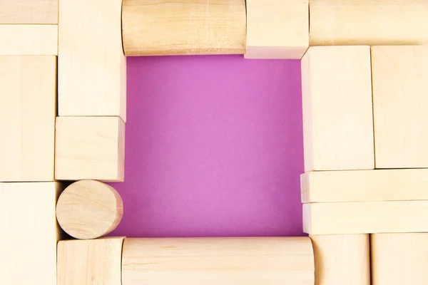 Trä leksak block på lila bakgrund — Stockfoto