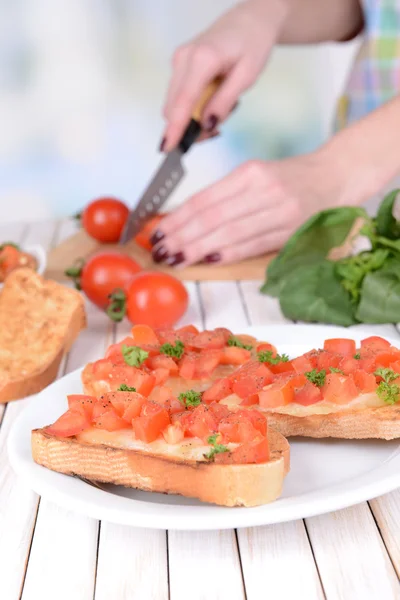 Delicious bruschetta with tomatoes on plate on table close-up — Stock Photo, Image