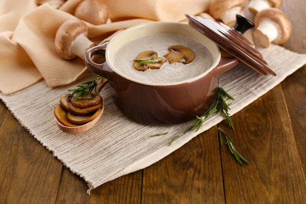 Mushroom soup in pot, on wooden background — Stock Photo, Image