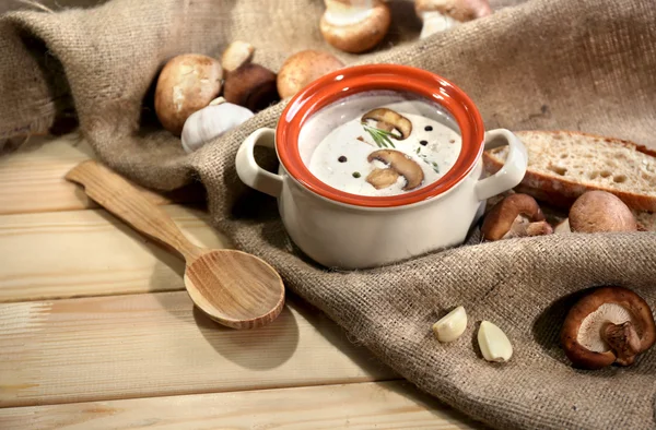 Mushroom soup in pot,on napkin,  on wooden background — Stock Photo, Image