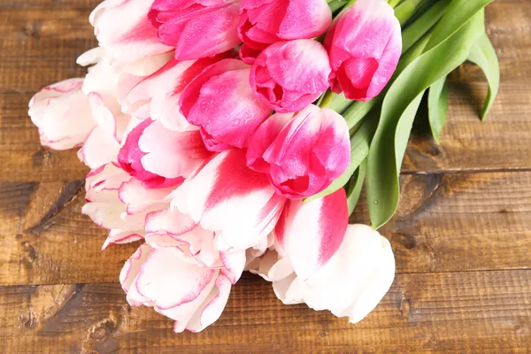 Beautiful tulips on color wooden background — Stock Photo, Image